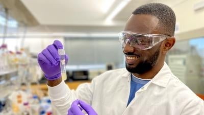 Rsearcher holds test tube