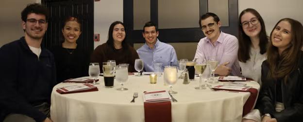Group of students pose at a celebration dinner.